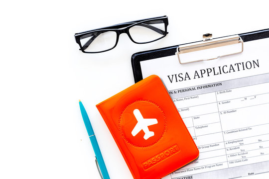 Visa processing, registration. Visa application form near passport cover with airplane on white background top view copy space