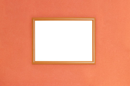 Wooden picture frame with blank white space for text on orange blurred background
