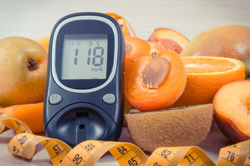 Glucose meter for checking sugar level, centimeter and nutritious fruits as healthy dessert for...