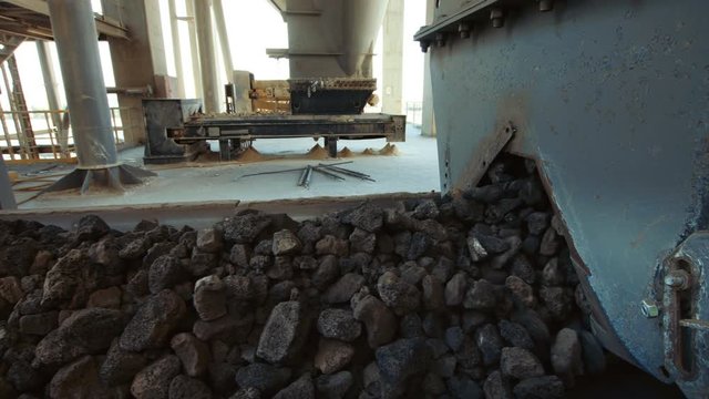 Industrial Clinker. Cement Manufacturing -  2 Clips, Pull Back, Push in to the iron ore in the raw mix bin machinery, raw mill bin equipment working, Manufacturing clinker (Cement) 4K footage