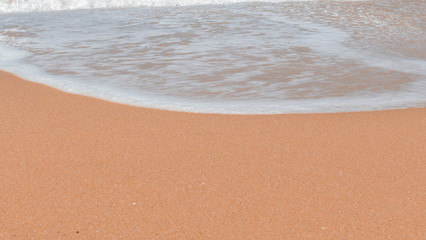 Fototapeta na wymiar Beach wave on the beach