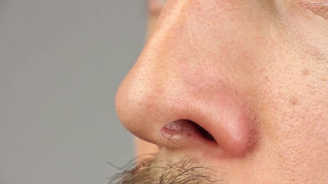 human nose sniff and move, macro closeup, caucasian man