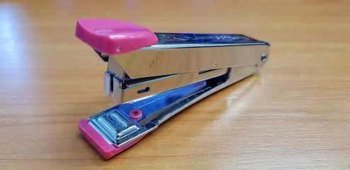 Pink stapler on table