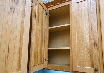 close up on wooden kitchen cabinet with door open