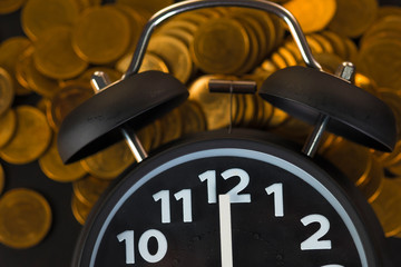 Alarm clock and coins stacks on working table, time for savings money concept, banking and business concept