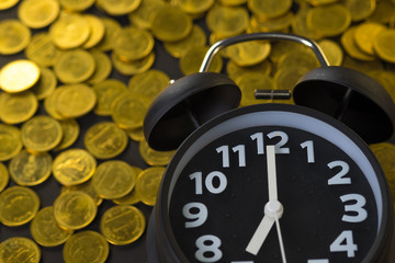 Alarm clock and coins stacks on working table, time for savings money concept, banking and business concept