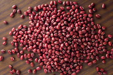 close up rad bead on wooden table. top view