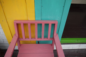 wooden chair and wall with bright colour