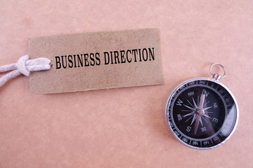 BUSINESS DIRECTION CONCEPT with keyboard, brown tag and compass.