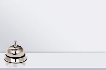 Reception service desk bell on light background