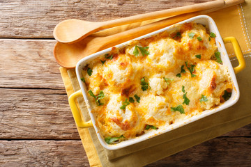 Vegetable casserole from cauliflower with cheese, eggs and cream close-up in a baking dish....