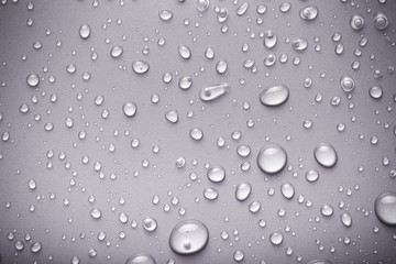 Drops of water on a color background. Gray. Toned