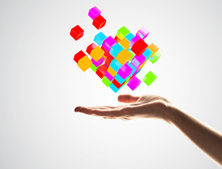 Cube color figure in male palm as symbol for integration. 3D rendering