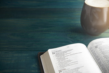 Fototapeta premium Holy Bible on a Blue Wooden Table Out for Studying