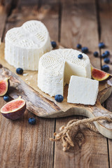ricotta cheese on rustic cutting board over wooden table