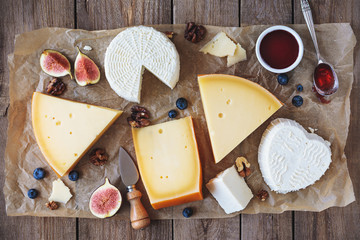 various types of cheese on rustic table top view