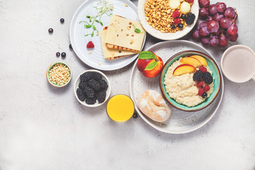 Breakfast. Oatmeal with berries, air rice with milk and toast, grapes