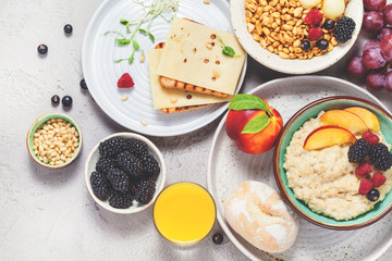 Breakfast. Oatmeal with berries, air rice with milk and toast, grapes