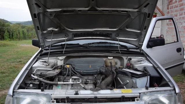 An engine on an old car starts and comes to life