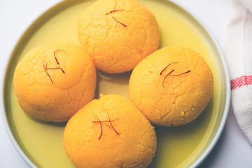 Rajbhog is a traditional Bengali sweet Rasgulla made during Navaratri festival using paneer or chena and flavoured with saffron and rose essence - obrazy, fototapety, plakaty