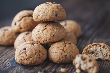 oatmeal cookies with chocolate on a wooden table