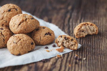 oatmeal cookies with chocolate on a wooden table