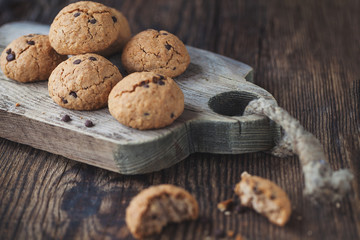 oatmeal cookies with chocolate on a wooden table