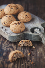 oatmeal cookies with chocolate on a wooden table