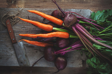 fresh organic carrot and beet from garden on rustic wooden table