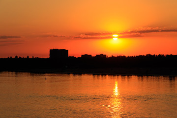 Naklejka premium Orange sunset over a river Dnieper in Kremenchug city, Ukraine