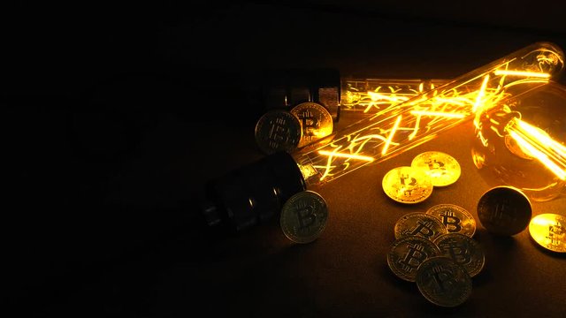 BTC among avid bulbs. The light flashes, an electrical short circuit. 4K, UHD, 50p, Cinematic,Closeup, Shallow depth of fields.