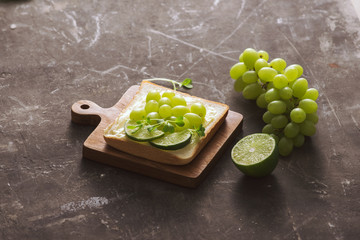A variety of fruit and bread in a dark background