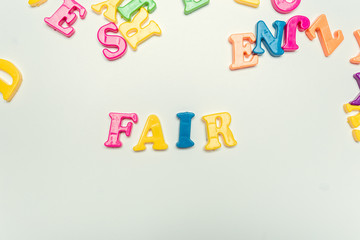 Plastic colorful letters with the text: Fair close up
