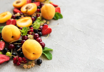 Fresh summer fruits on a concrete background
