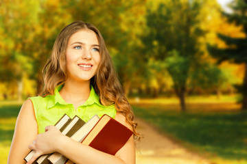 Fototapeta premium Young pretty girl portrait in autumn park