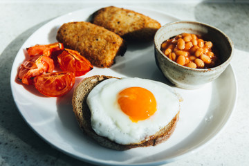 fried eggs with bacon and vegetables