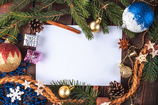 Christmas decorations, balls, anisee tree, cinnamon, cones, spruce branch, gifts on a wooden background. Christmas and New Year holidays. Copy space. Top view. Christmas flat lay and background
