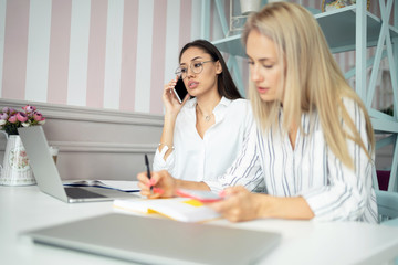 millennial woman reading news on cellular. positive female blogger using smartphone device for...