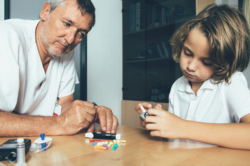 Doctor watches a diabetic child