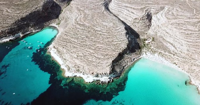 Aerial view of Spiaggia dei Conigli next to the island of Lampedusa, Sicily, Italy with Mediterranean sea. Italian summer landscape seen from the sky with drone flying over beach
