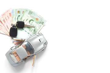Car model and Thailand currency on white background. Car loan concept