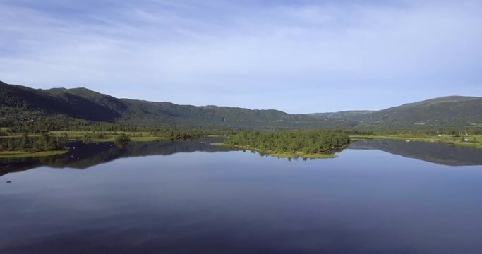 Aerial shot of calm beautiful lake reflection in Geilo, Norway.