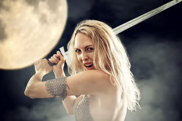 danger sexy warrior viking girl with sword attack