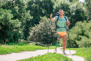 Positive young man with paralysis enjoying weekend activities