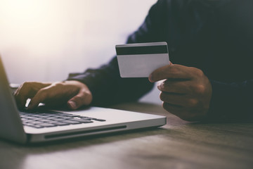 Man typing laptop for online shopping and pay by credit card, Online payment and shopping concept