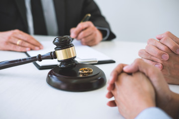 Agreement prepared by lawyer signing decree of divorce (dissolution or cancellation) of marriage, husband and wife during divorce process with male lawyer or counselor and signing of divorce contract