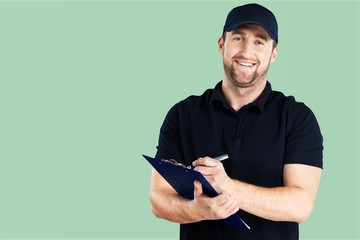 Delivery man with clipboard on office background