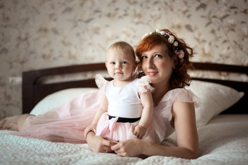 gentle mom and daughter in real room, motherhood