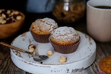 Homemade muffins decorated with sugar powder, hazel nuts