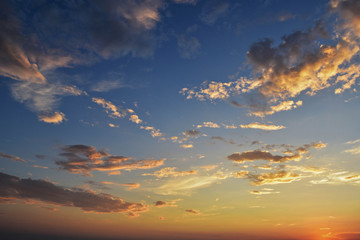 Sunset with sun rays, sky with clouds and sun.